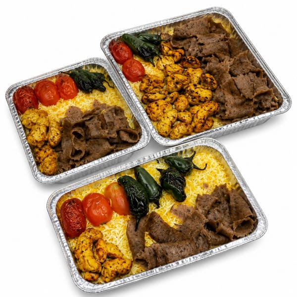 Three catering trays filled with rice, grilled chicken, gyro meat, roasted tomatoes, and jalapeños.